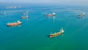 You are a headline writer for OilMarketCap.com. Write ONE new headline for this oil and gas news story. Rules: under 60 characters, investor-focused, no clickbait, no character counts, no options, no explanations. Return the headline only — nothing else. Story title: Strait of Hormuz Traffic Grinds to a Halt Again as Iran Fires on Passing Ships